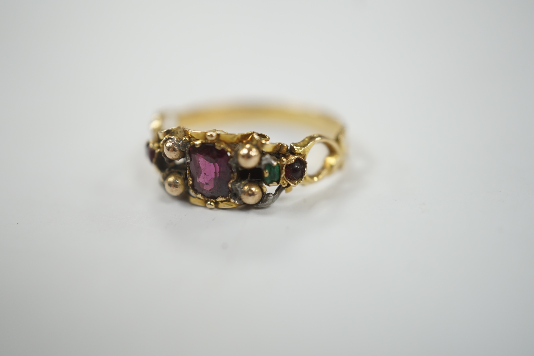 A Victorian yellow metal, garnet, ruby? and emerald set dress ring, (stones missing), size L, gross weight 1.8 grams.